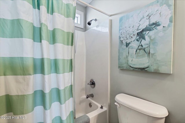 bathroom featuring shower / tub combo with curtain and toilet