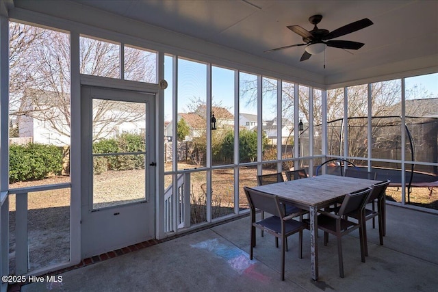 unfurnished sunroom with ceiling fan