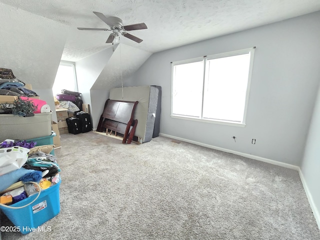 bedroom featuring multiple windows, carpet floors, and a textured ceiling