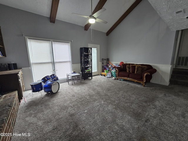 interior space featuring ceiling fan, beam ceiling, high vaulted ceiling, and a textured ceiling