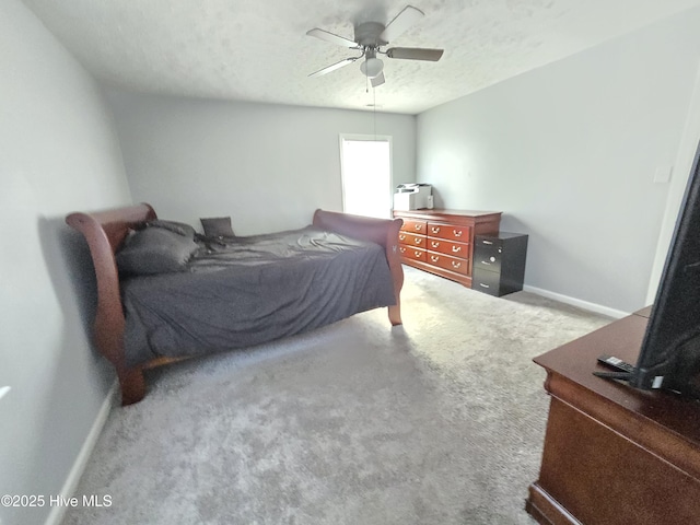 carpeted bedroom with ceiling fan and a textured ceiling