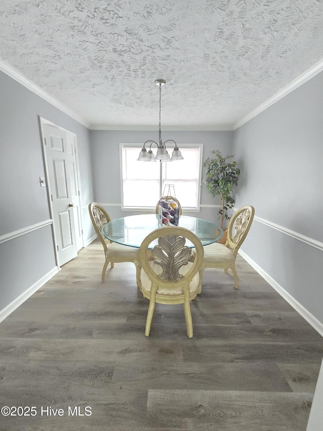 unfurnished dining area featuring ornamental molding, dark wood-type flooring, and a textured ceiling