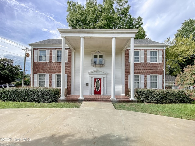 greek revival inspired property featuring brick siding