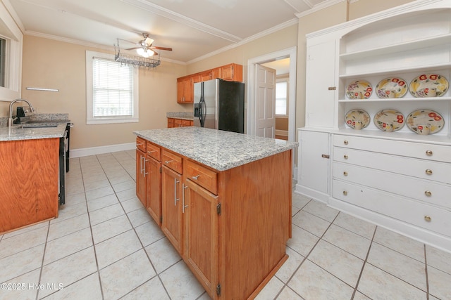 kitchen featuring crown molding, brown cabinetry, a sink, and stainless steel fridge with ice dispenser