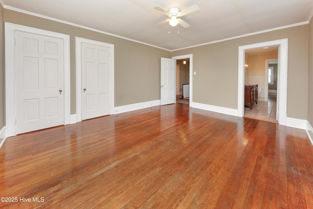 unfurnished bedroom with light wood-type flooring, baseboards, and crown molding