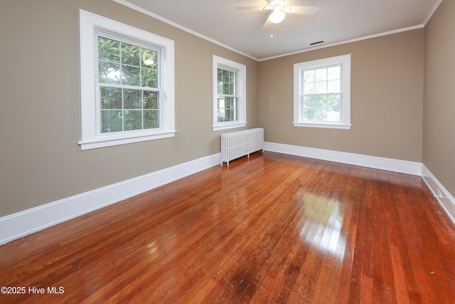 unfurnished room featuring radiator, crown molding, and baseboards