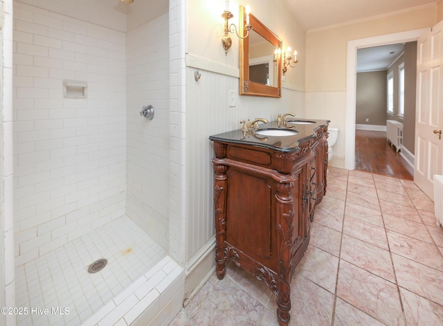 full bath with a stall shower, radiator, wainscoting, and a sink