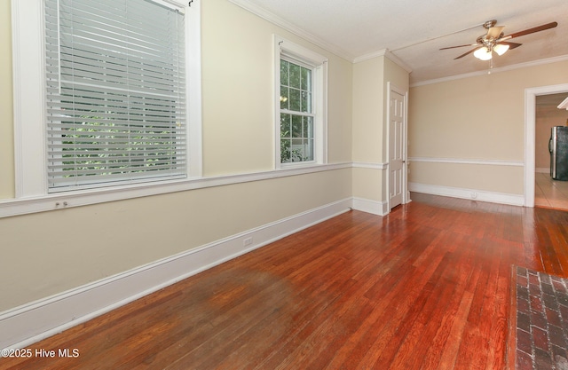 unfurnished room featuring ornamental molding, ceiling fan, baseboards, and wood finished floors