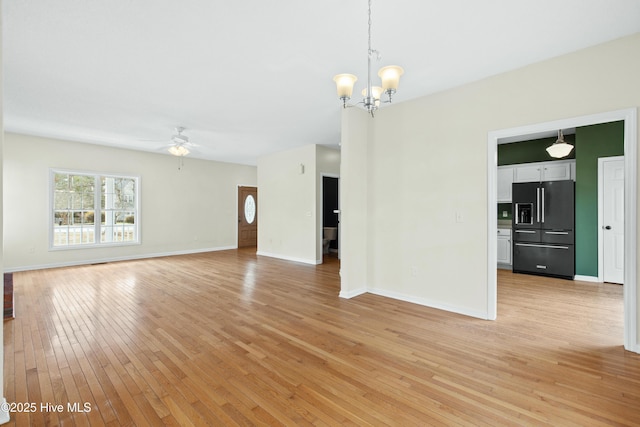 1652 Chadwick Shores Dr, Sneads Ferry, NC 28460 - unfurnished living room with a ceiling fan, light wood-type flooring, a chandelier, and baseboards