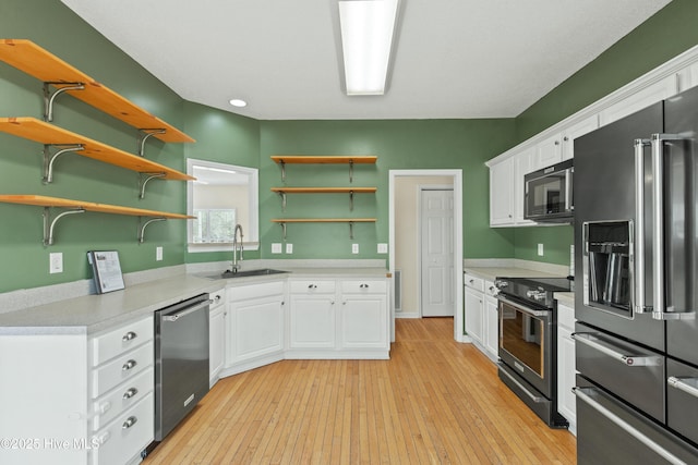 1652 Chadwick Shores Dr, Sneads Ferry, NC 28460 - kitchen with appliances with stainless steel finishes, a sink, open shelves, white cabinetry, and light countertops