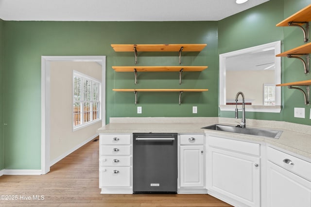 1652 Chadwick Shores Dr, Sneads Ferry, NC 28460 - kitchen with open shelves, dishwasher, a sink, light wood-style floors, and white cabinetry