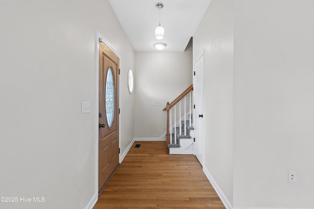 1652 Chadwick Shores Dr, Sneads Ferry, NC 28460 - entrance foyer with light wood-type flooring, stairway, and baseboards