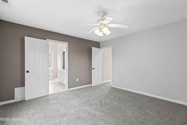 1652 Chadwick Shores Dr, Sneads Ferry, NC 28460 - unfurnished bedroom featuring carpet flooring, baseboards, ensuite bathroom, and ceiling fan