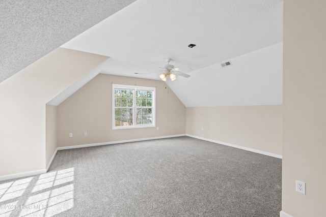 1652 Chadwick Shores Dr, Sneads Ferry, NC 28460 - additional living space with carpet, ceiling fan, lofted ceiling, baseboards, and a textured ceiling