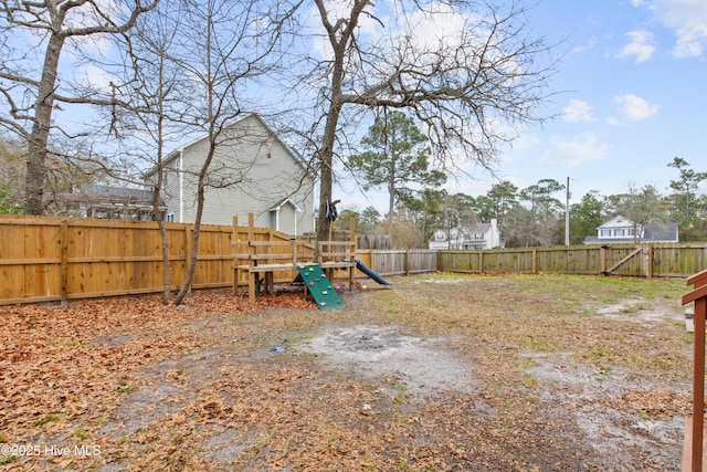 1652 Chadwick Shores Dr, Sneads Ferry, NC 28460 - fenced backyard featuring a playground