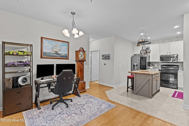 office area featuring a chandelier and light hardwood / wood-style flooring