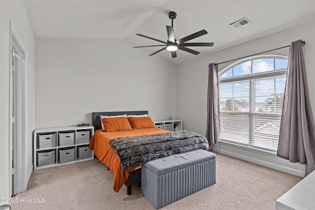 carpeted bedroom with vaulted ceiling and ceiling fan