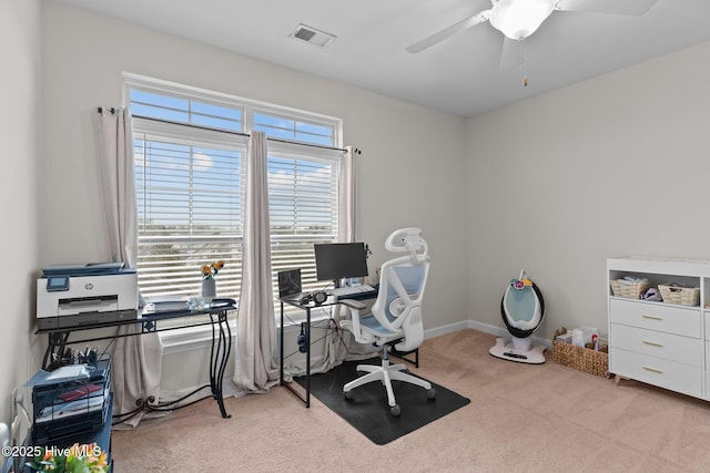 carpeted office space with ceiling fan