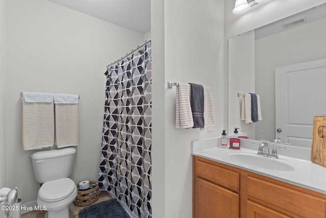 bathroom featuring vanity, toilet, and curtained shower