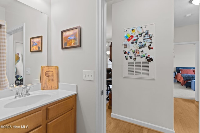 bathroom with hardwood / wood-style flooring and vanity