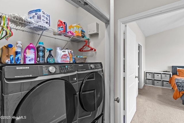 laundry area with washer and clothes dryer and carpet flooring