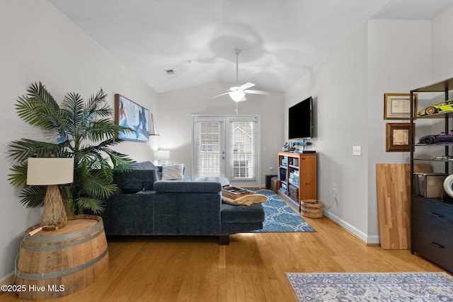 living room featuring hardwood / wood-style flooring, ceiling fan, and lofted ceiling