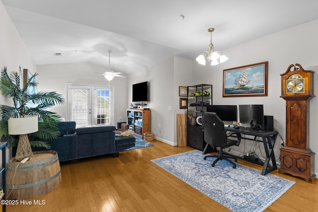 office featuring lofted ceiling, ceiling fan with notable chandelier, and light hardwood / wood-style flooring