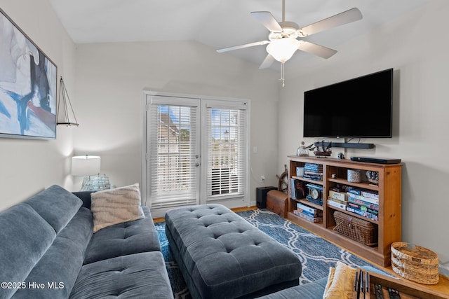 living room featuring vaulted ceiling, wood-type flooring, and ceiling fan