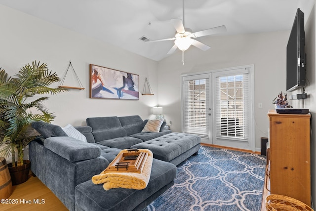 living room with hardwood / wood-style floors, vaulted ceiling, french doors, and ceiling fan