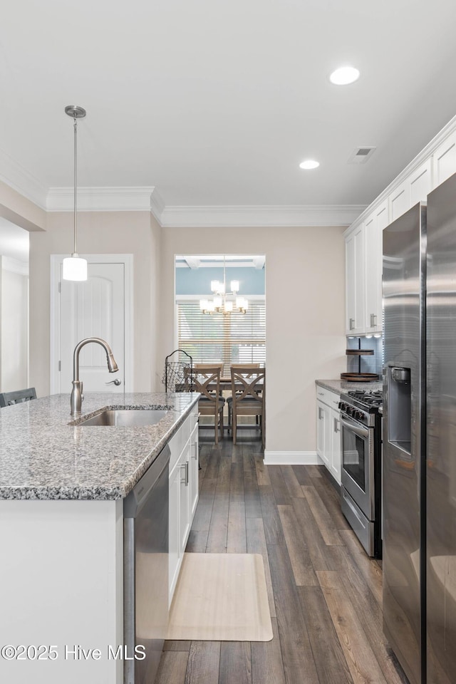 kitchen with white cabinetry, appliances with stainless steel finishes, sink, and pendant lighting