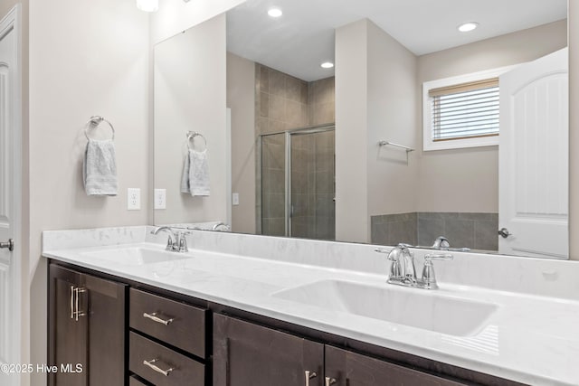 bathroom with an enclosed shower and vanity