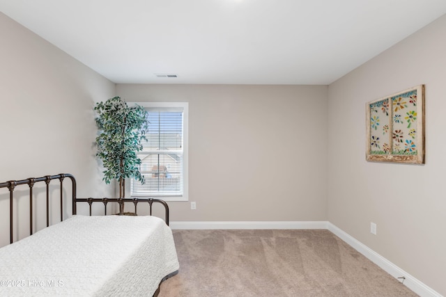 bedroom with light colored carpet