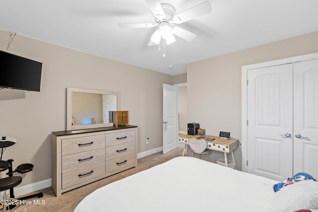 carpeted bedroom featuring ceiling fan and a closet