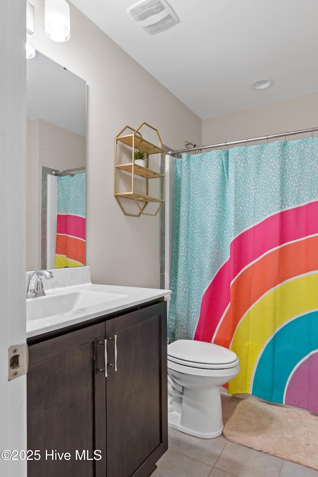 bathroom with vanity, a shower with curtain, tile patterned floors, and toilet