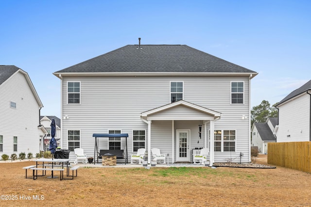 rear view of property featuring a yard and a patio area