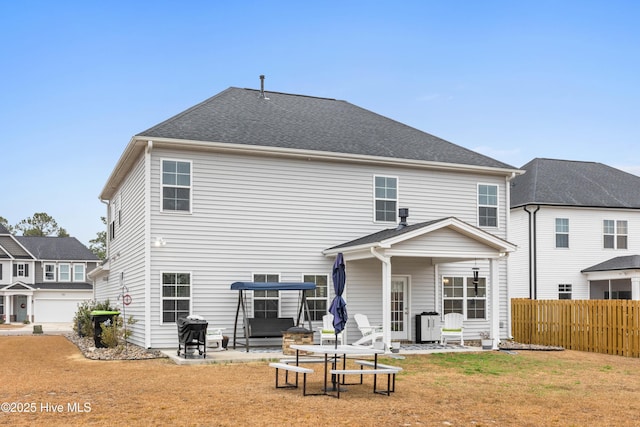 back of house featuring a patio and a lawn