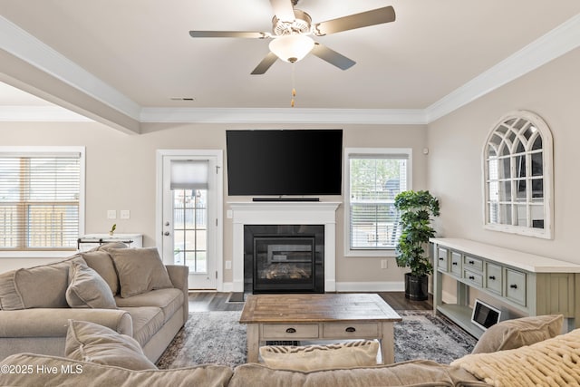 living room with crown molding, dark hardwood / wood-style floors, and a wealth of natural light