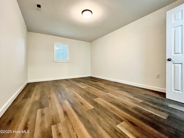 spare room featuring wood-type flooring