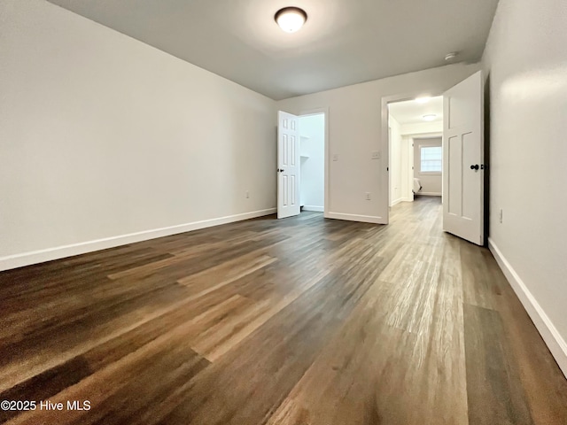 unfurnished bedroom featuring dark wood-type flooring