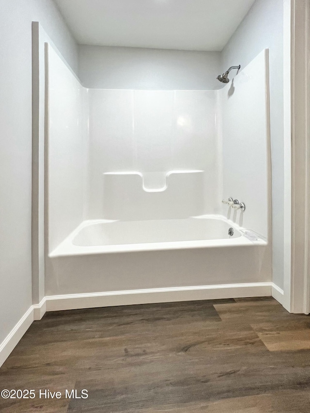 bathroom with hardwood / wood-style floors and shower / bath combination