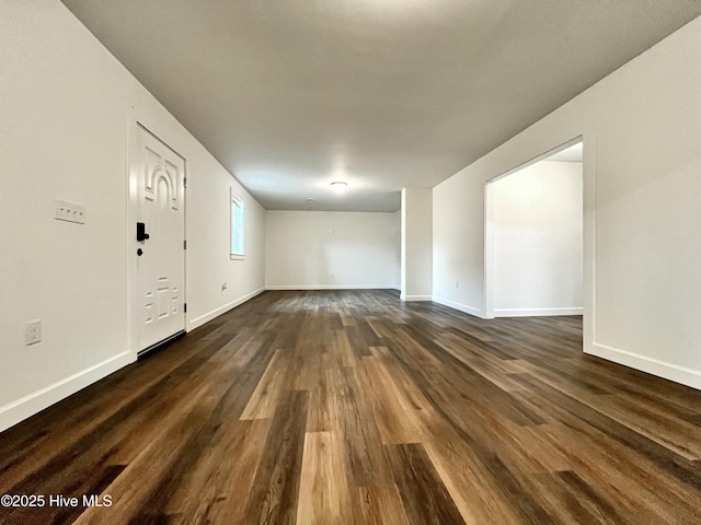 spare room featuring dark wood-type flooring