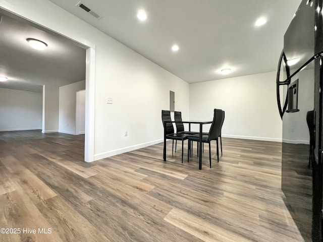 dining space with dark wood-type flooring