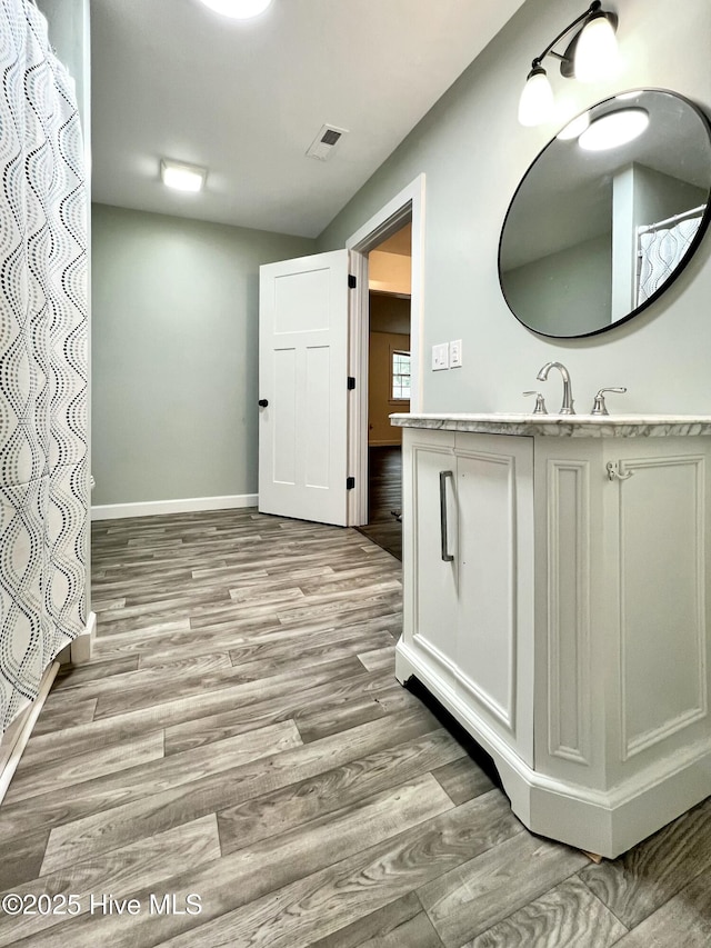 bathroom featuring hardwood / wood-style flooring and vanity