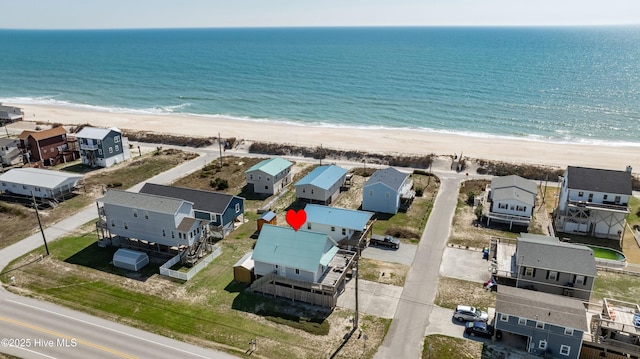 drone / aerial view featuring a water view and a beach view