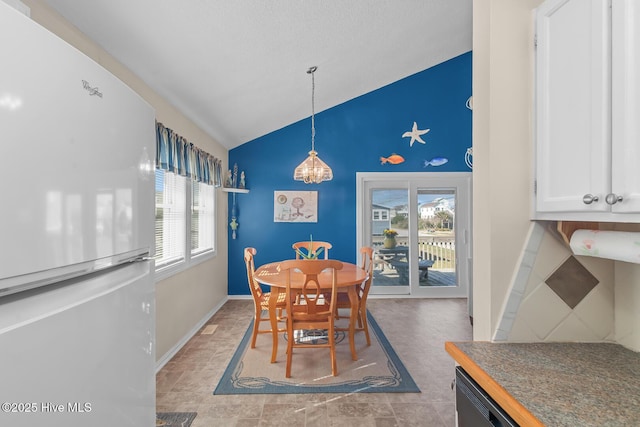 dining area with vaulted ceiling