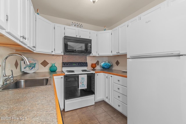 kitchen with white appliances, sink, decorative backsplash, and white cabinets