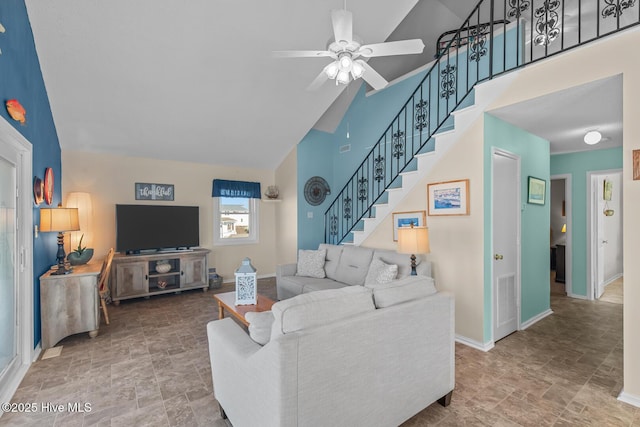 living room featuring ceiling fan and high vaulted ceiling