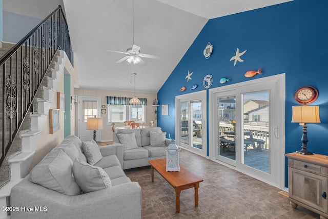 living room with ceiling fan and high vaulted ceiling