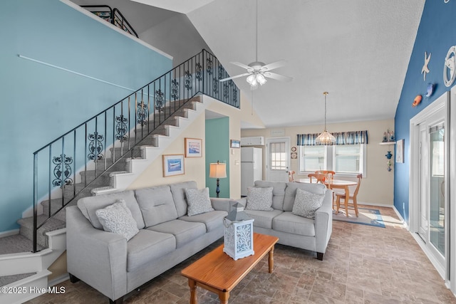 living room with ceiling fan and high vaulted ceiling