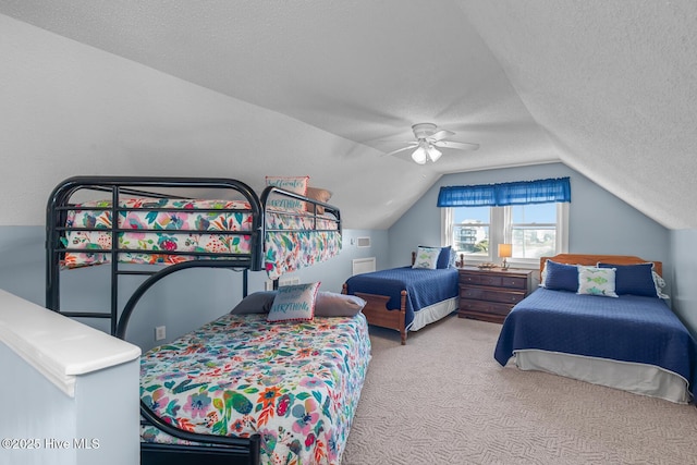 bedroom with lofted ceiling, ceiling fan, a textured ceiling, and carpet flooring